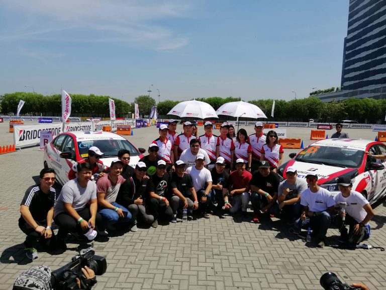 Toyota car club participants pose with the TMP executives.