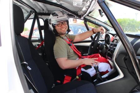 Chris Van Hooven strapped into the seat sans the top of his ill-fitting racing suit.