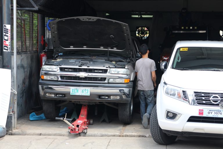 The mechanic placed a crocodile jack and jack stand under the front end of our Tahoe and lifted it.