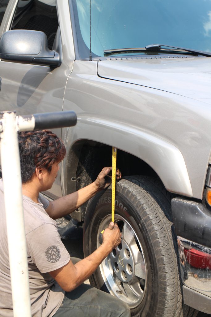 After another short drive to load the suspension, the front wheel gaps were found to be 7” on the right and 6 ½” on the left. The mechanic adjusted the right front wheel gap to measure 6 ½” same as the left side for a slight rake that would straighten when the Tahoe is fully laden with passengers and cargo.