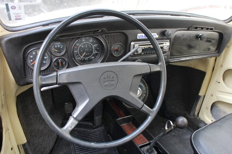 Padded dash and Wolfsburg logo at center of steering wheel.