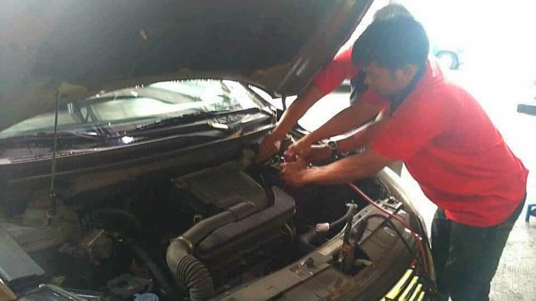 Motolite technicians check our old battery before installing a new one.